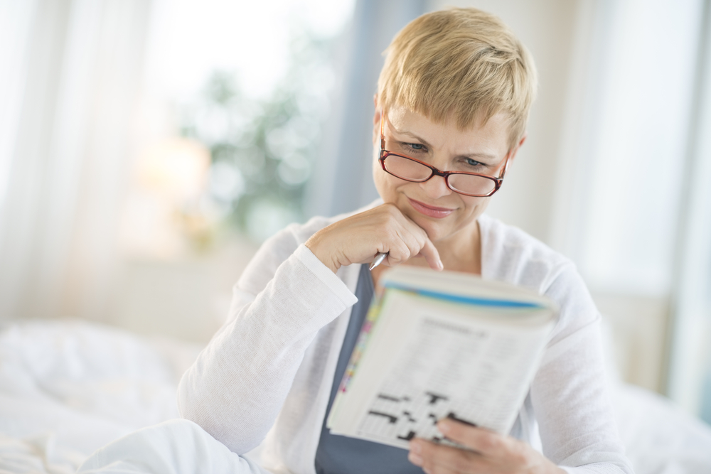 Woman Doing a Crossword Puzzle to Improve Memory During Menopause