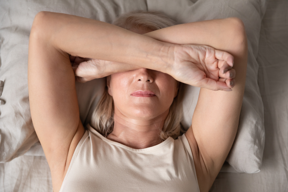 woman with arms over face suffering brain fog